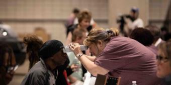 Woman giving an eye exam 